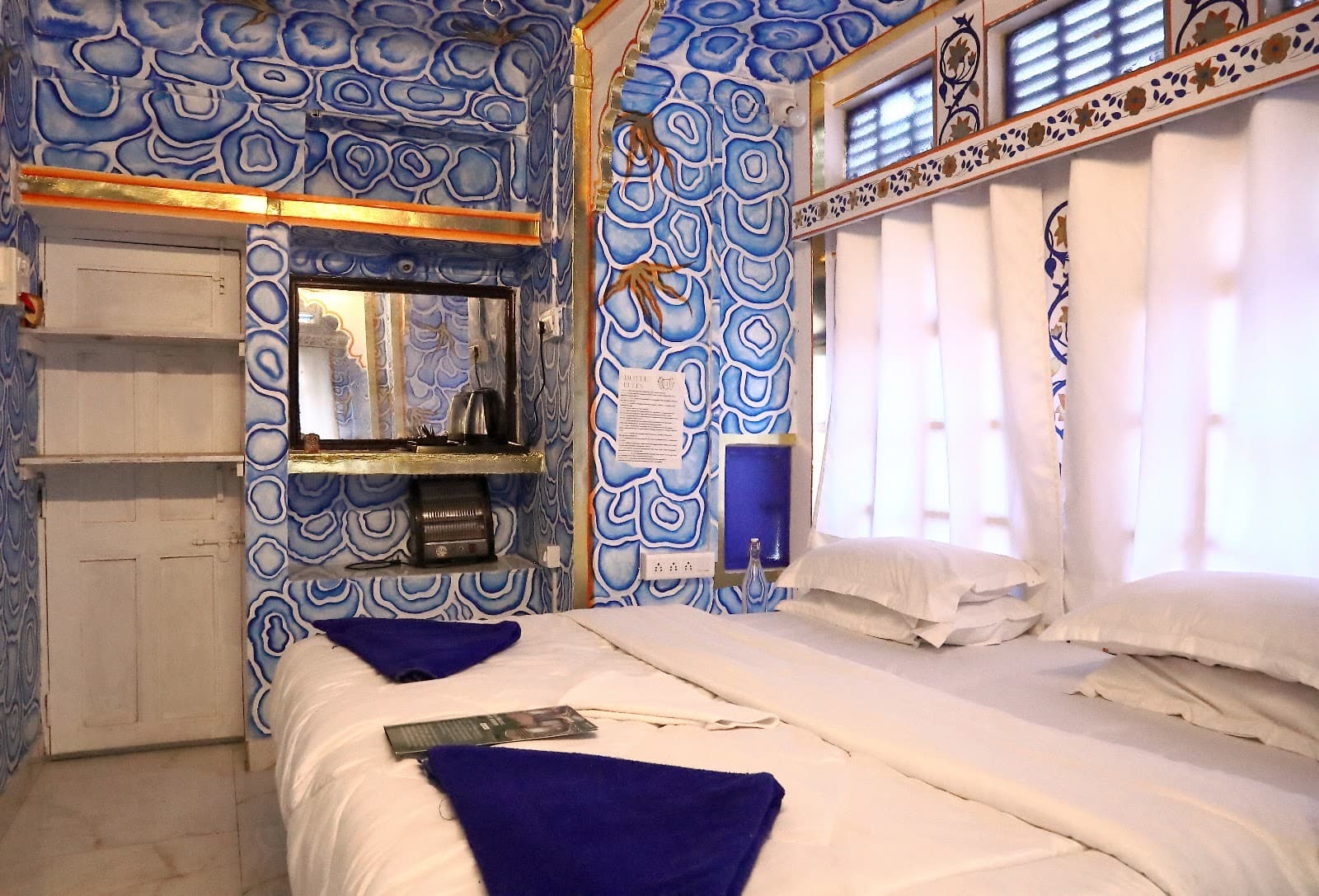 Deluxe Room 101 with blue hand-painted walls